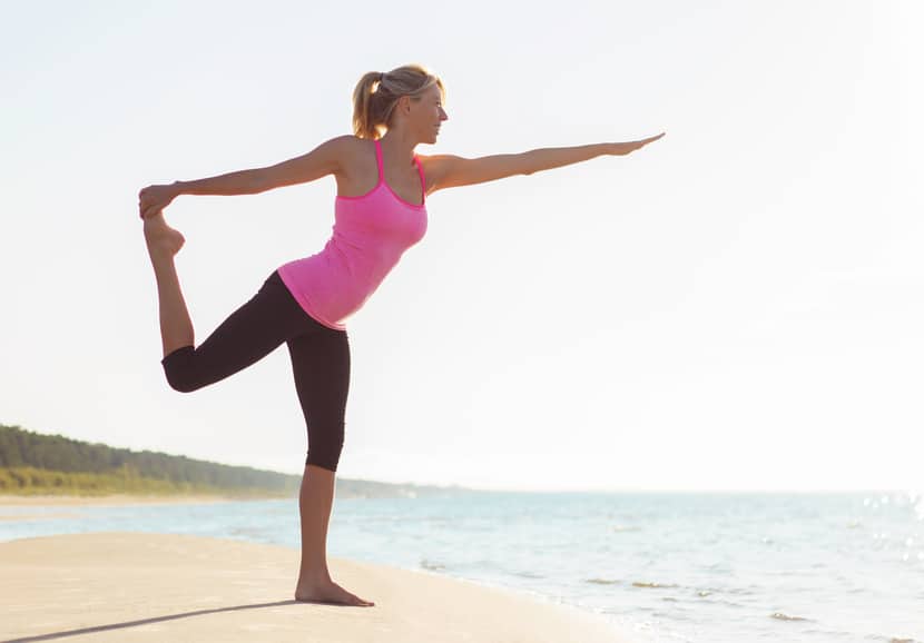 Woman stretching at the beach