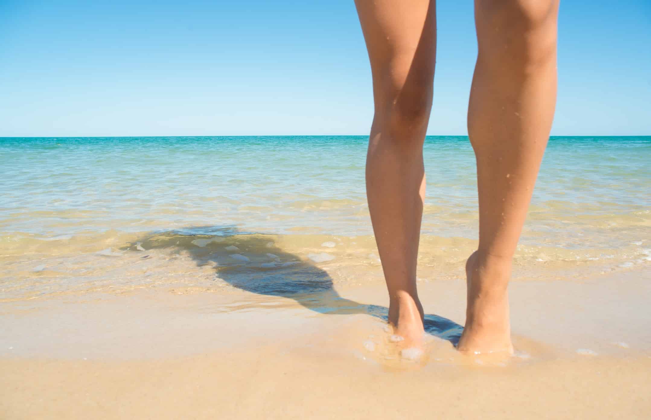 woman's legs at the beach