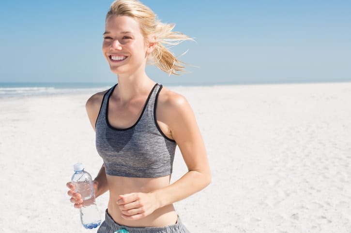 Woman jogging with water