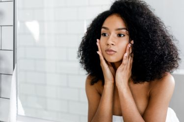 beautiful woman touching her face