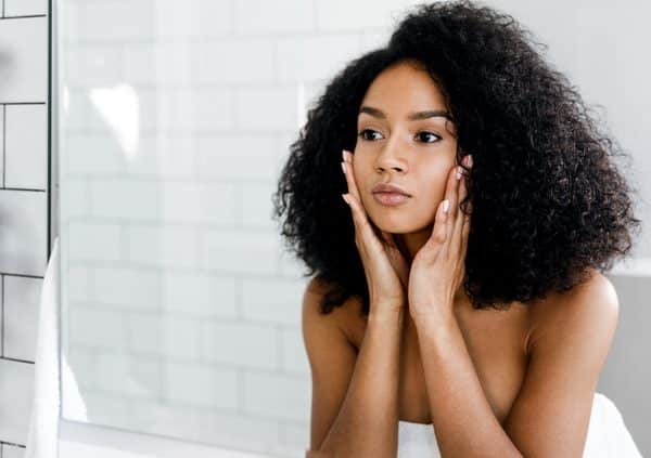 beautiful woman touching her face