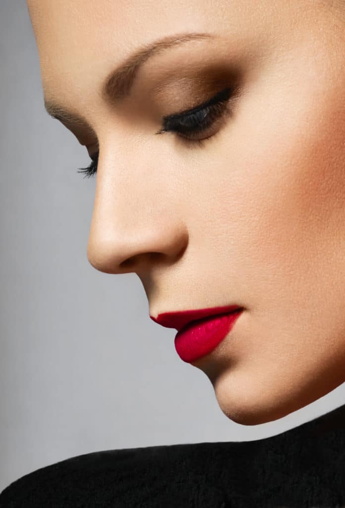 Close-up beauty portrait of young female, red lipstick make-up