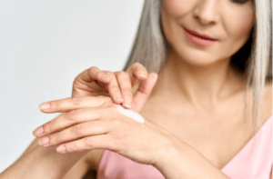 mid age woman applying hand cream